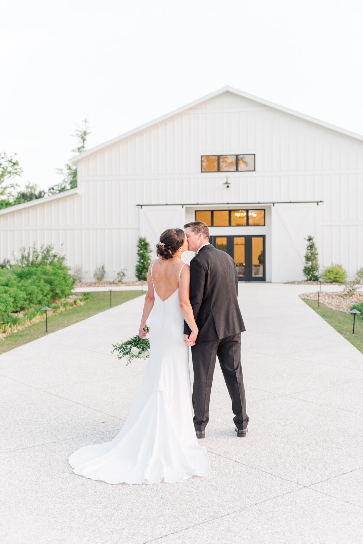 couple walking holding hands at the venue at white oak farms