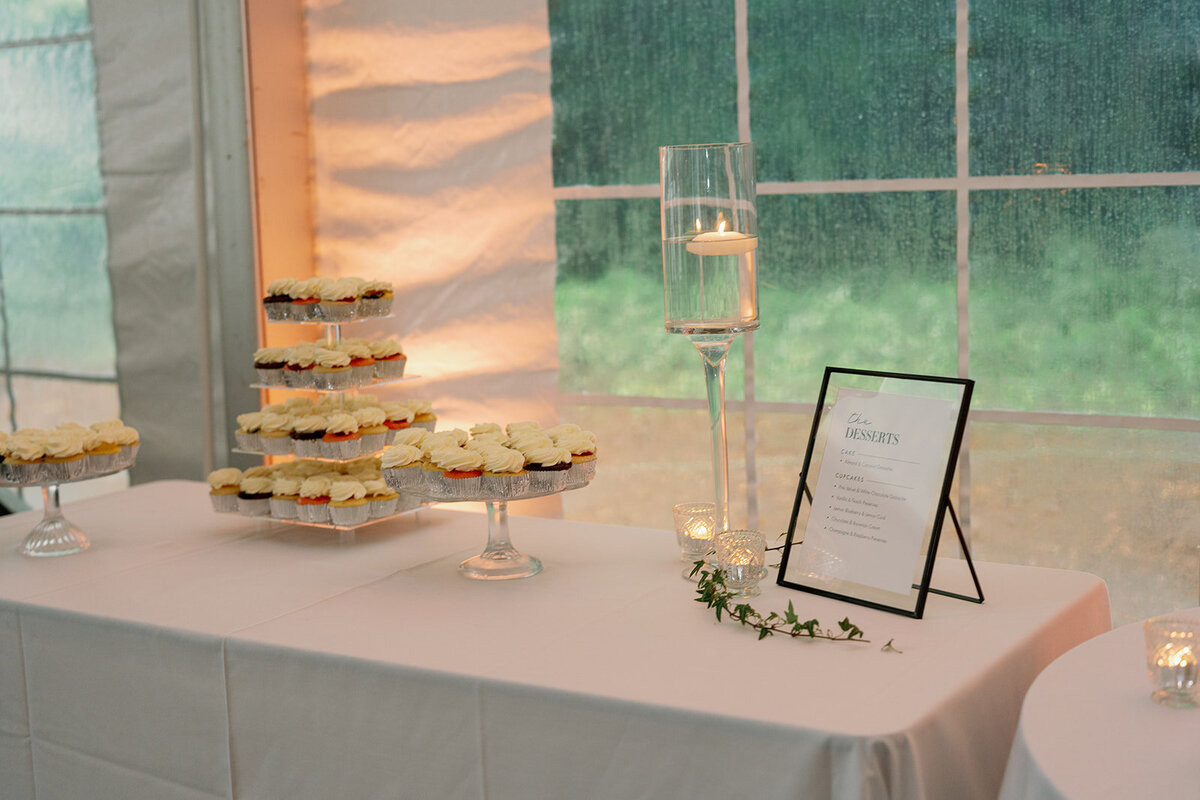 Elegant white and green tablescape with candles at The Morris Estate wedding reception.