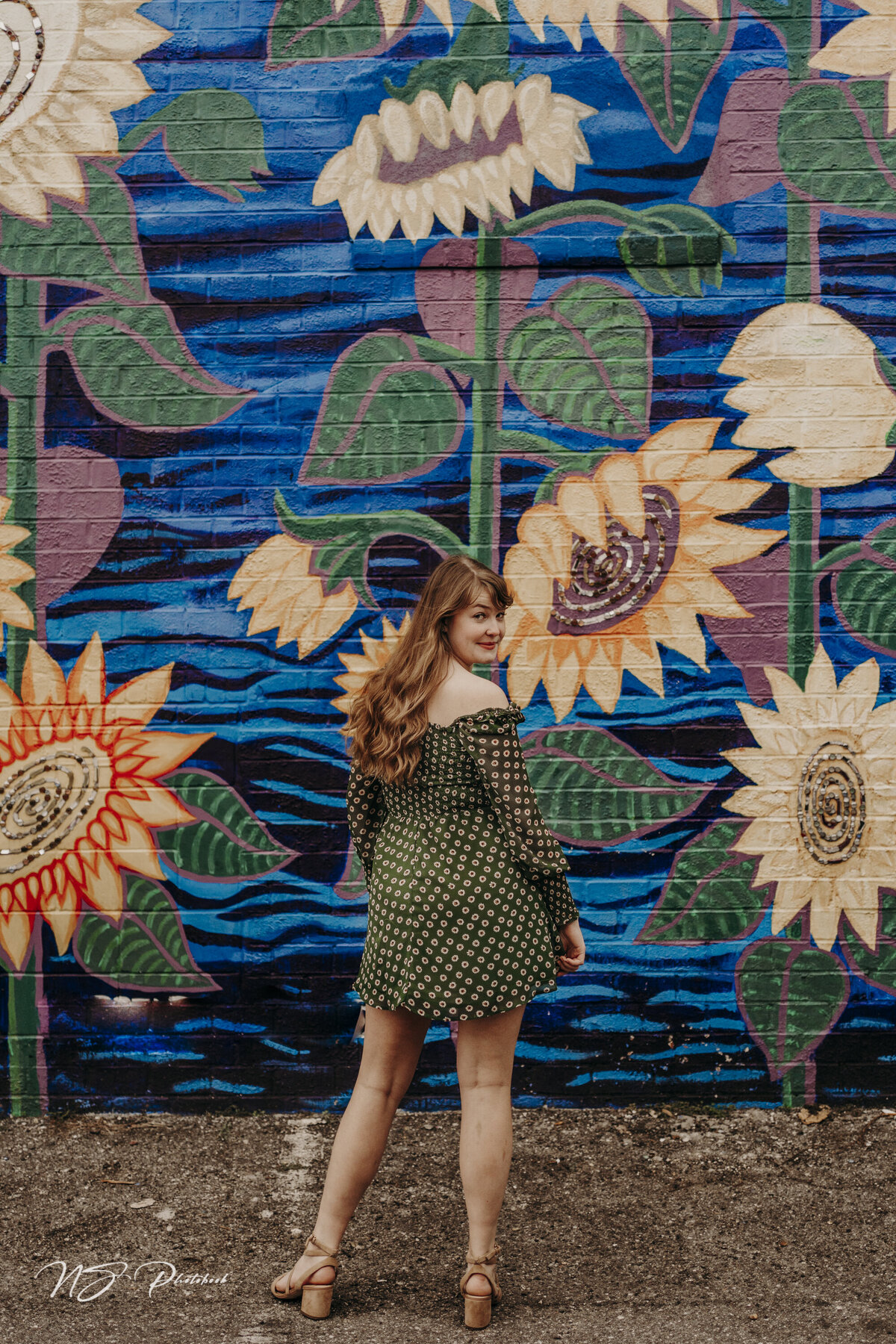 girl in front of mural