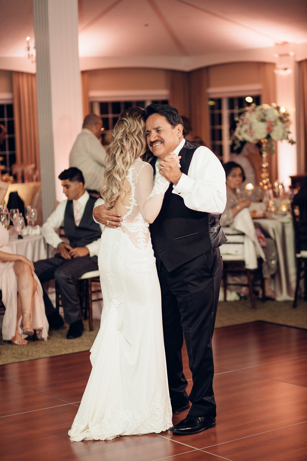 Wedding Photograph Of Man In Black Suit Smiling While Dancing With The Bride Los Angeles