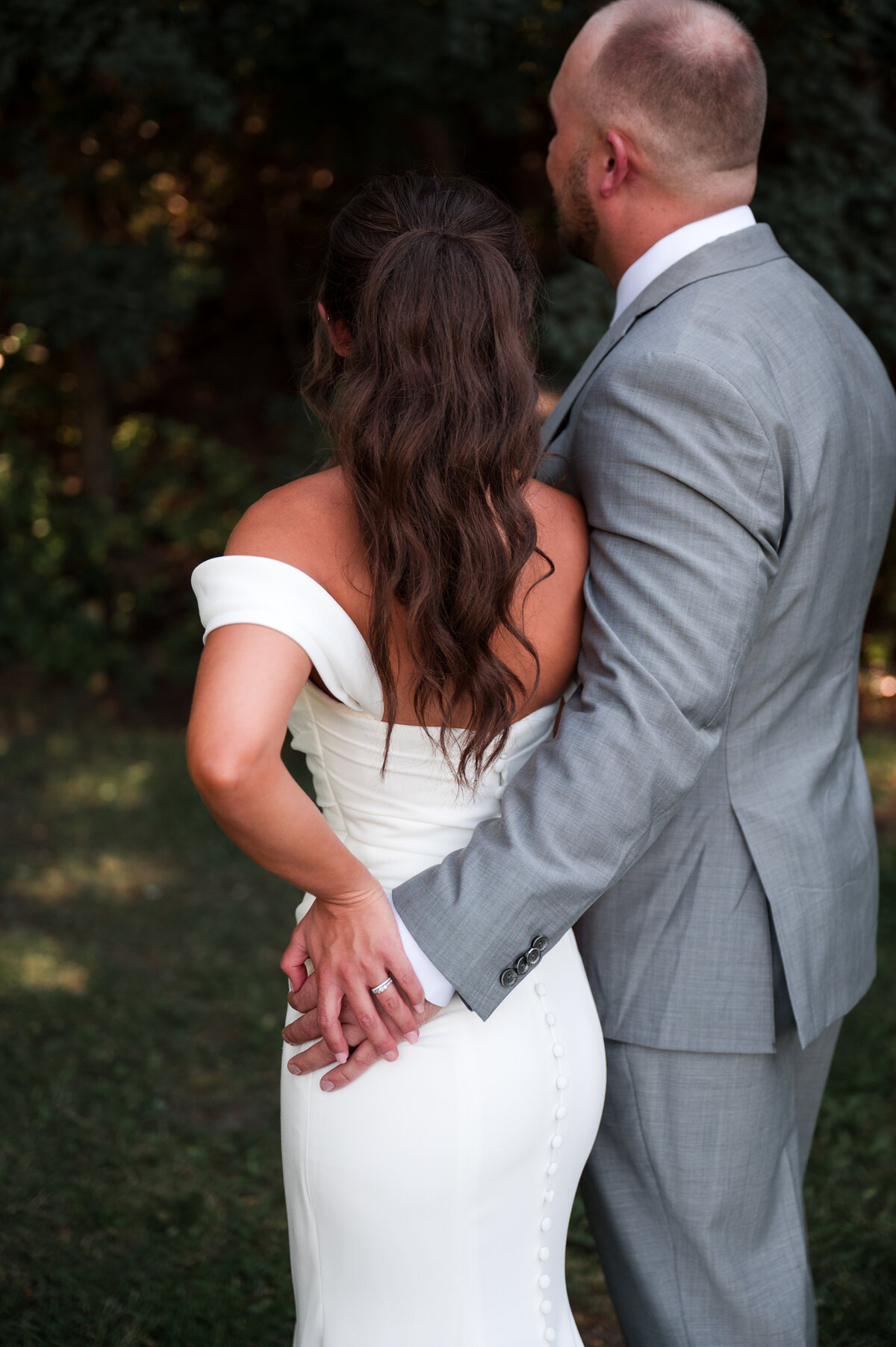 bride and groom holding onto each other