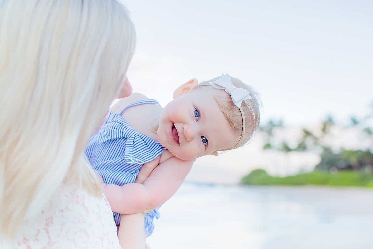 Cute little girl smiling at the camera during her family photography session with Love + Water Maui