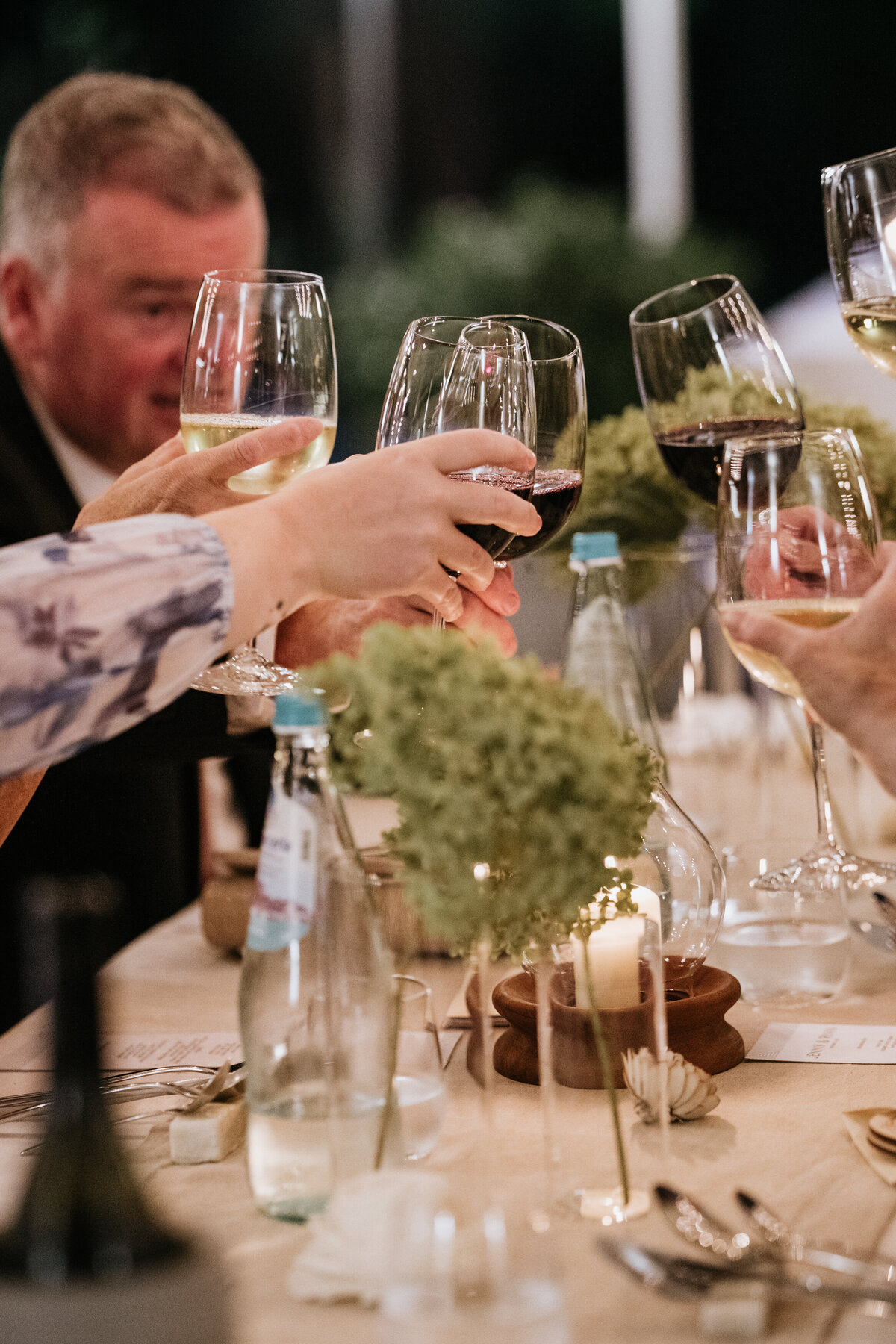 Guest toasting with wine at wedding dinner