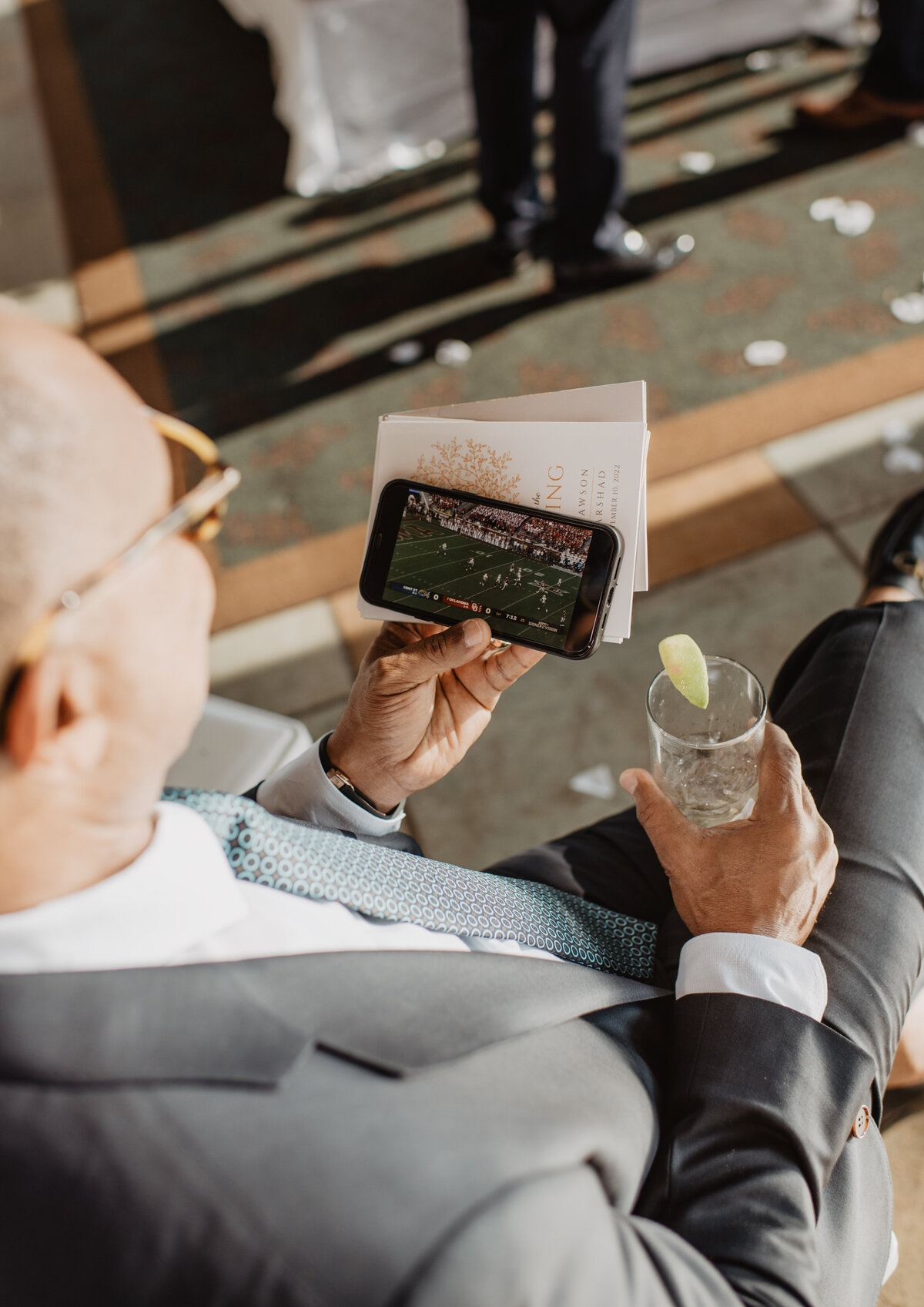 Photographers Jackson Hole capture guest watching football game during wedding ceremony