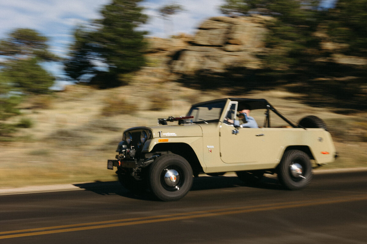 Couple driving their jump through the mountain desert in Utah with shutter blur, by Andrea-Marie Photography