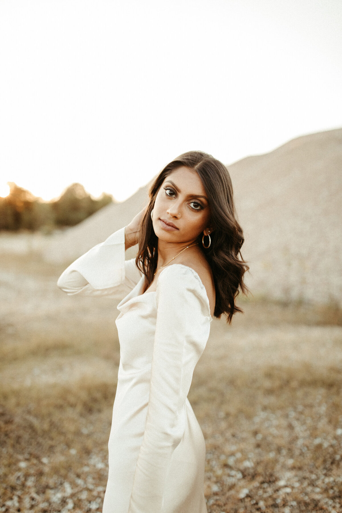 Girl senior in silk dress posing during her photoshoot