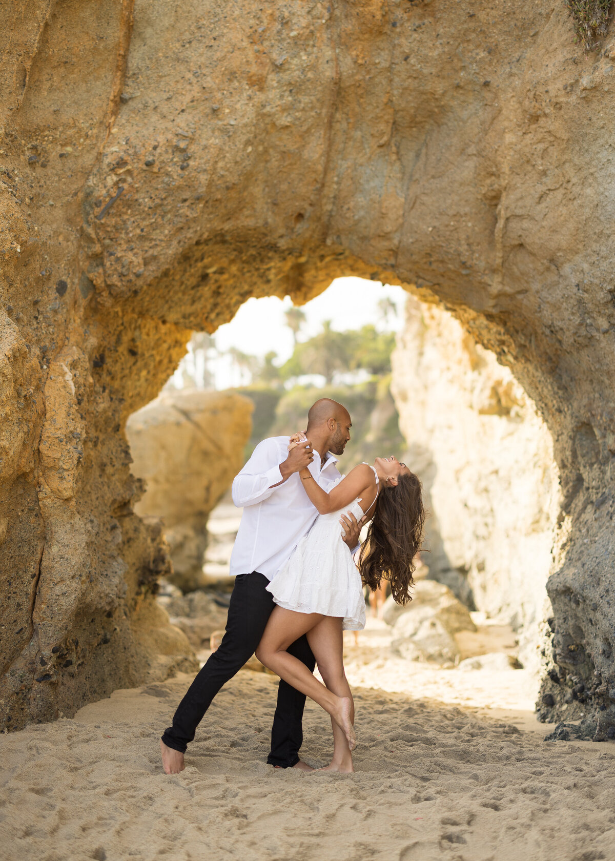 candid carefree beach engagement photo