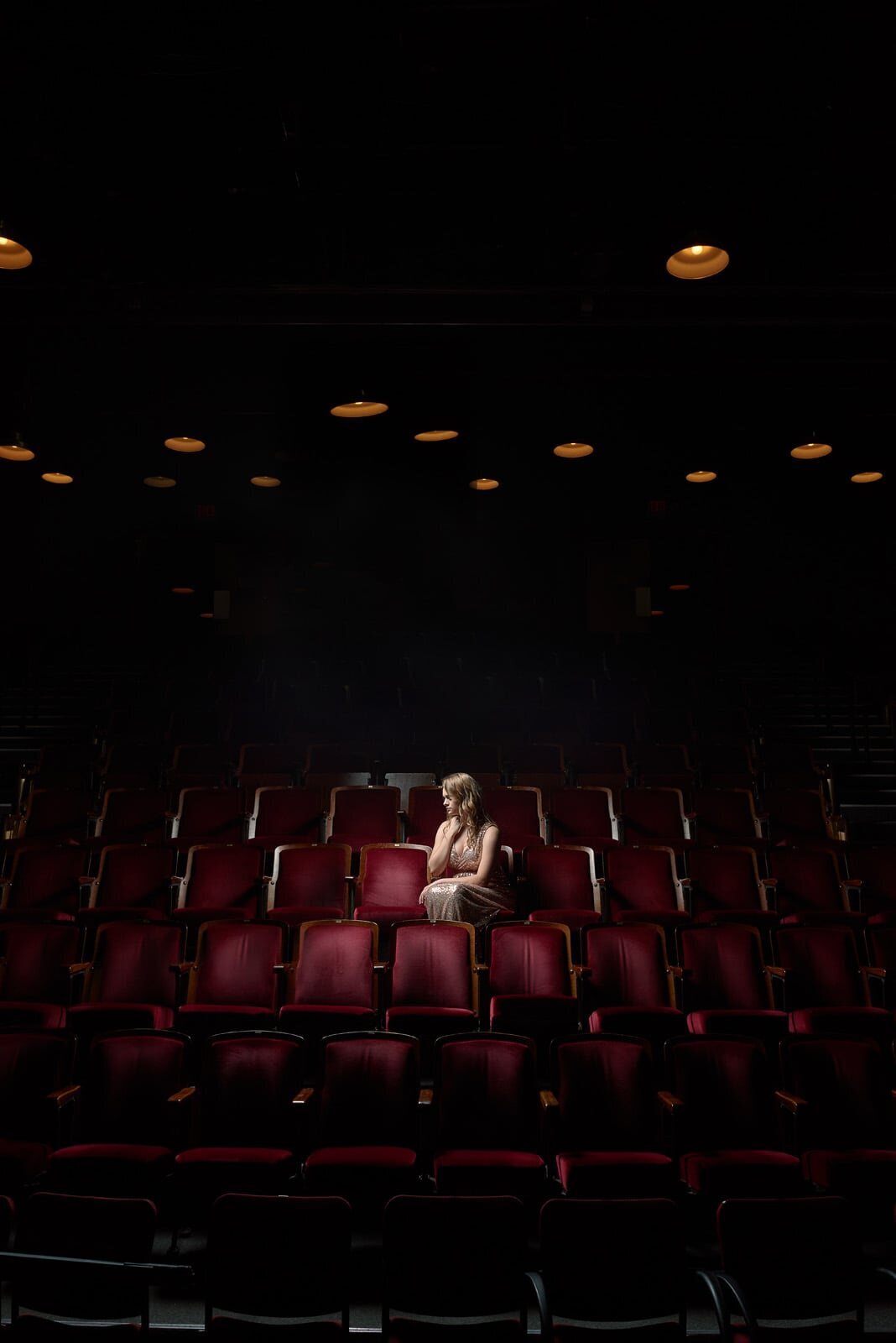 Woman Alone in Theater Seats-13