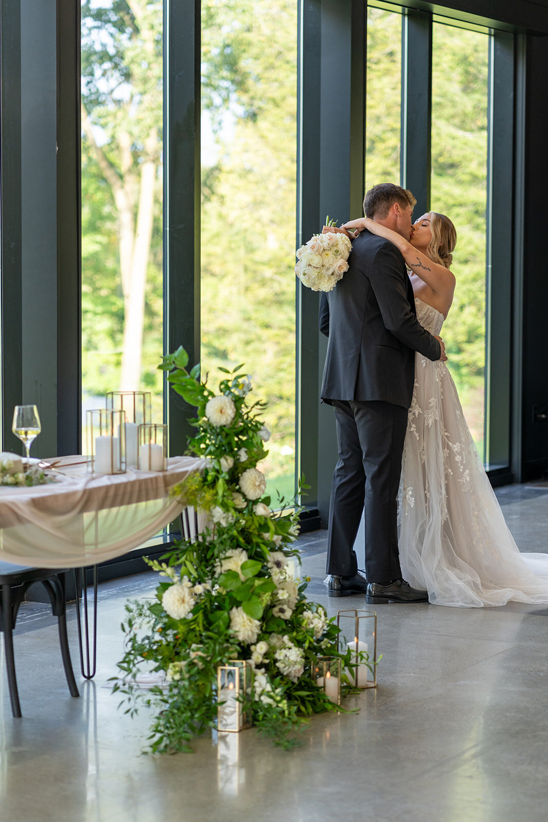 A bride and groom hugging in front of their head table in the reception hall; taken by columbus wedding photographer A James Visuals.