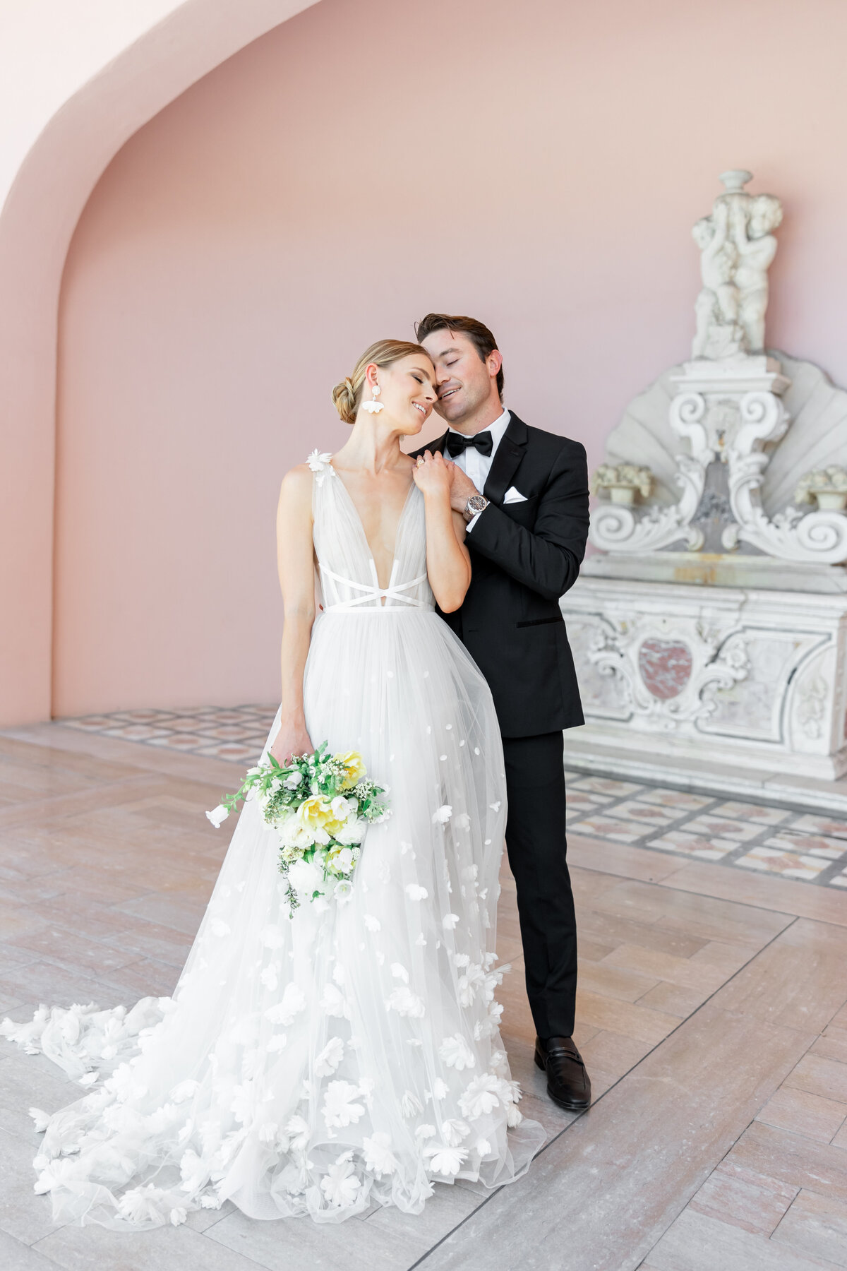 couple leaning in toward each other with pink background by orlado florida wedding photographers