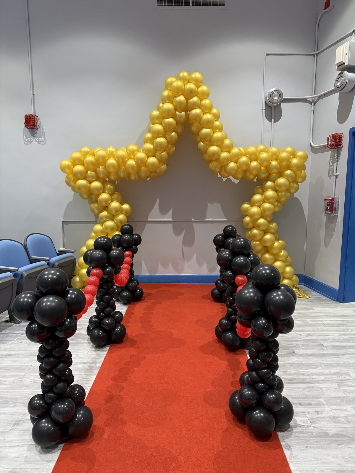 Star balloon arch with red carpet