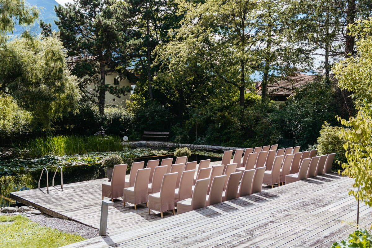 Outdoor ceremony setup beside natural pond at La Vimea vegan hotel