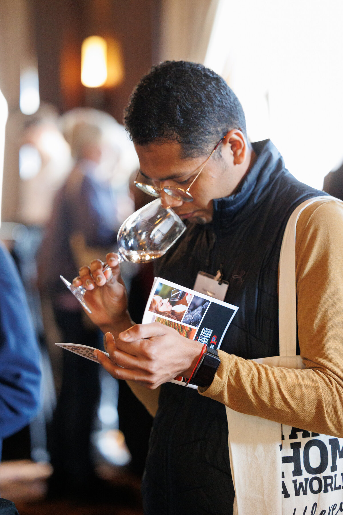 male smelling a  glass of wine