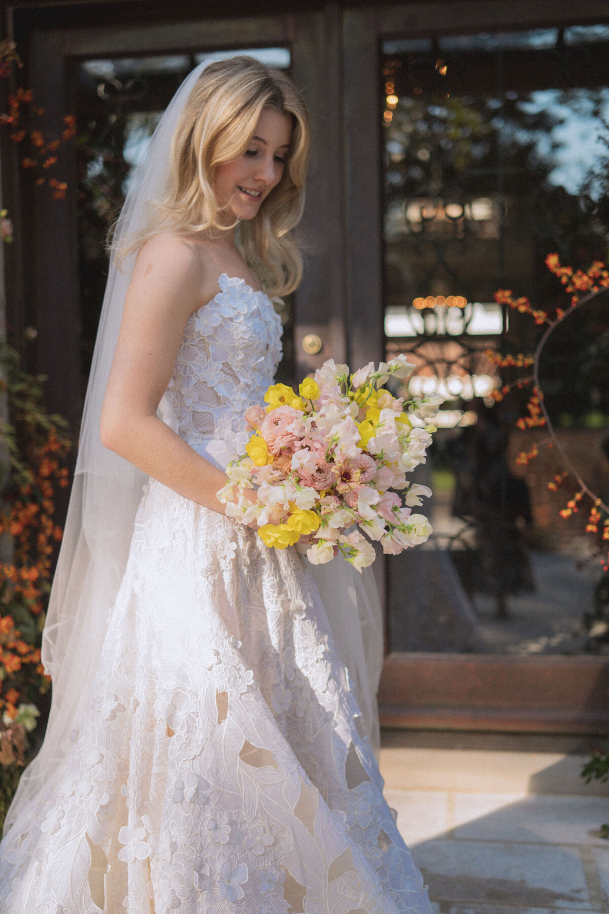 Product clustered bridal bouquet with sweet peas, local zinnias, and butterfly ranunculus. Elegant and simple bridal bouquet and bridal party bouquets with hues of blush and pops of yellow. Unique fall wedding design for private residence wedding in Nashville, TN. Bridal party wearing brown and wedding design with touches of brown. Design by Rosemary & Finch Floral Design in Nashville, TN.