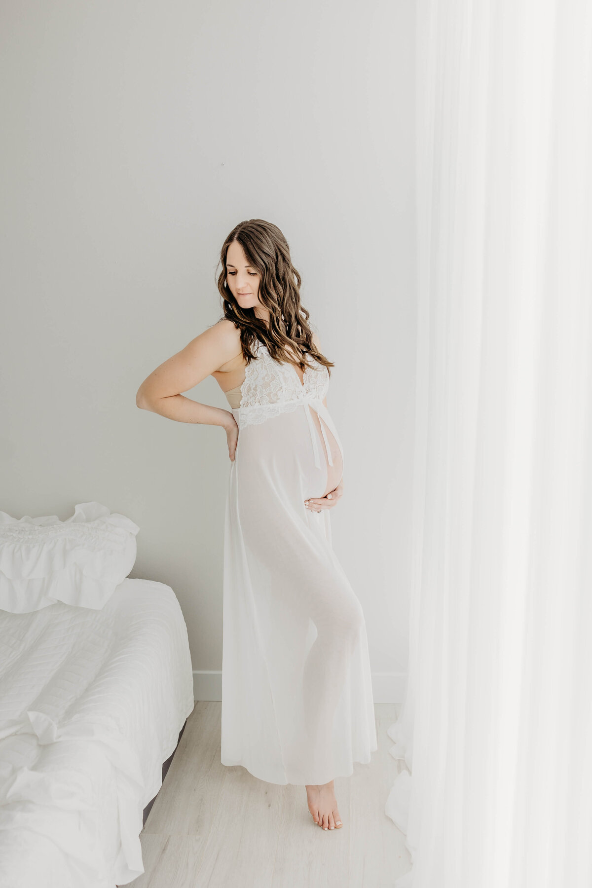 Intimate maternity portrait of mom in sheer white gown pregnant near Eau Claire Wisconsin