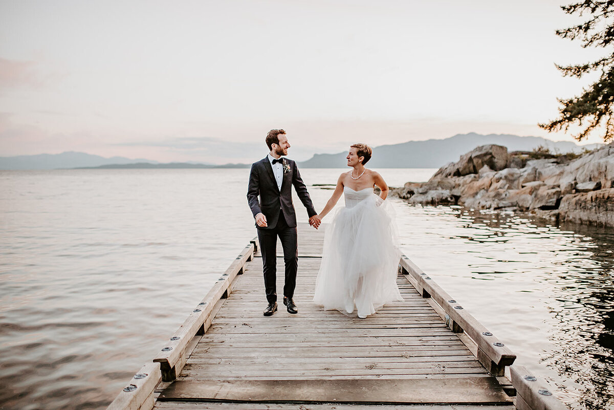 Couple jumping like they've just won the lottery during their portrait session at their small wedding in Pender Harbor B.C
