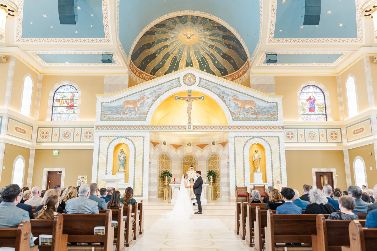 bride and groom participating in a traditional Catholic wedding ceremony