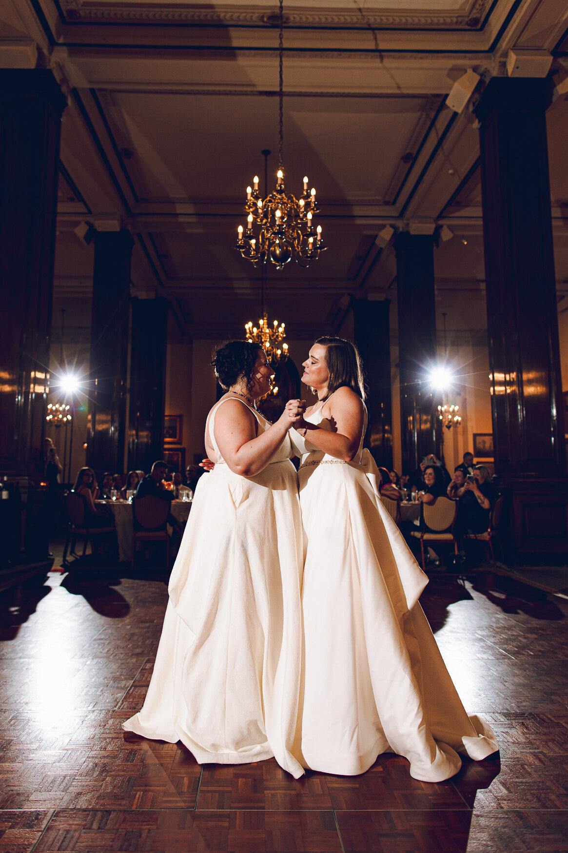A queer couple share their first dance at their wedding at the Union League Club Chicago Wedding