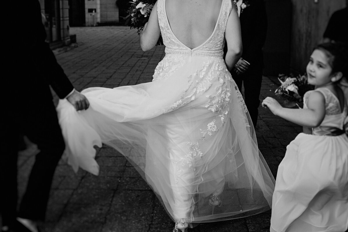 black and white bridal party image walking away