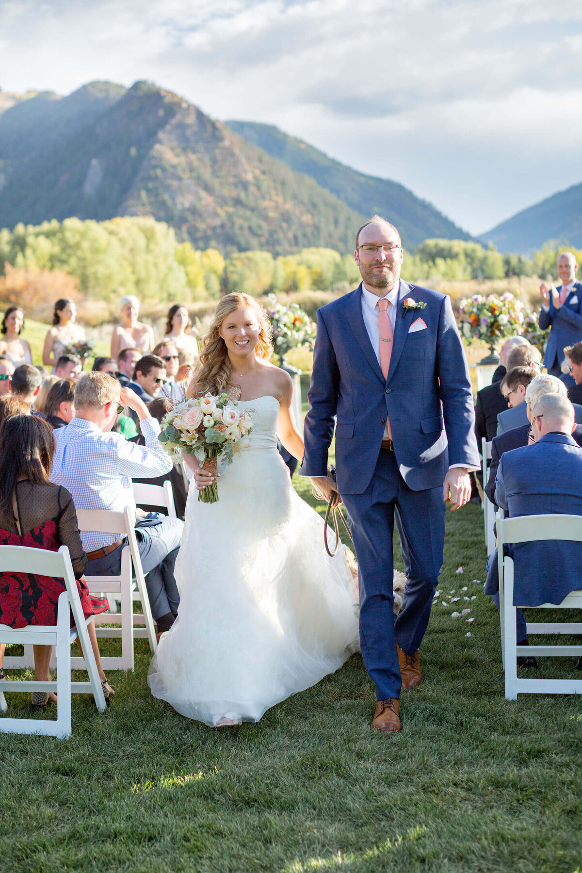 bride and groom recess up the aisle following ceremony at aspen meadows resort