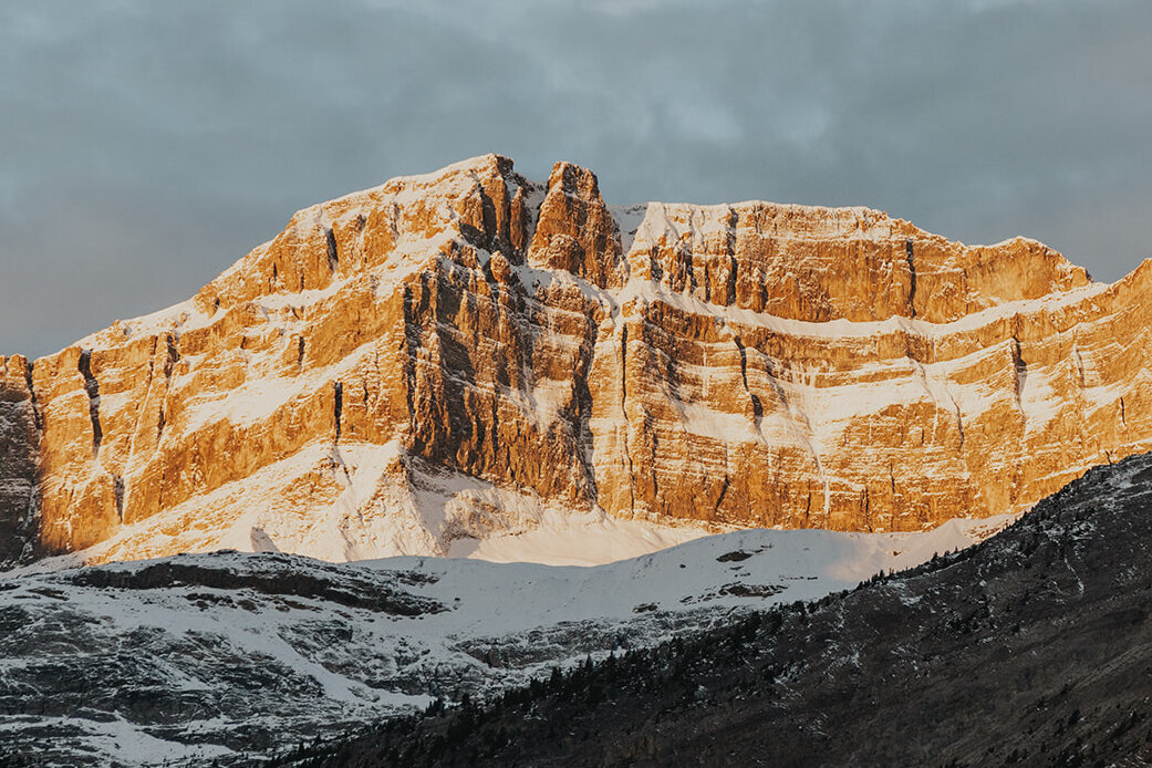 The sun lights up the tip of the mountains during a sunrise ceremony in Banff National Park