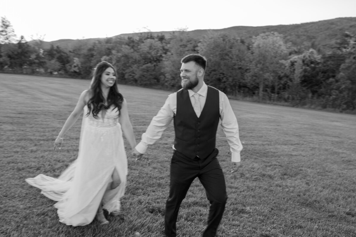 The groom is leading the bride during their golden hour photos after their elopement.