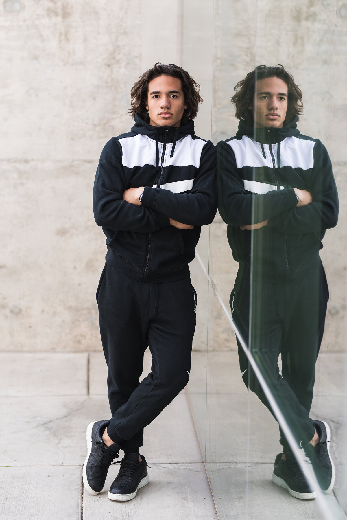 Senior guy in track suit leaning on wall