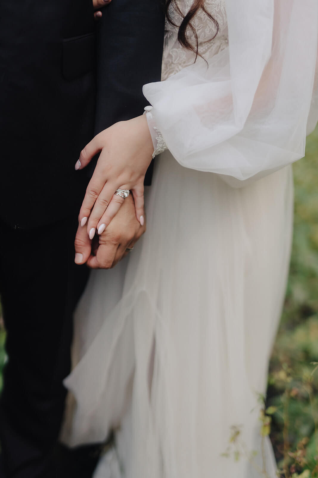 bride and grooms hands showing rings