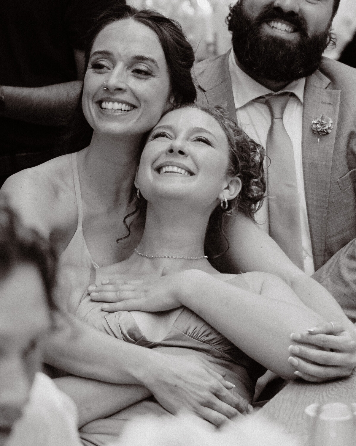 sweet moment of bridesmaids cuddling together showing deep friendship