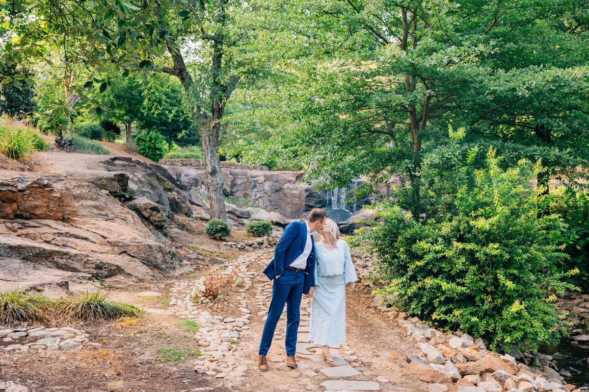 couple kissing at engagement session at the rock quarry in south carolina