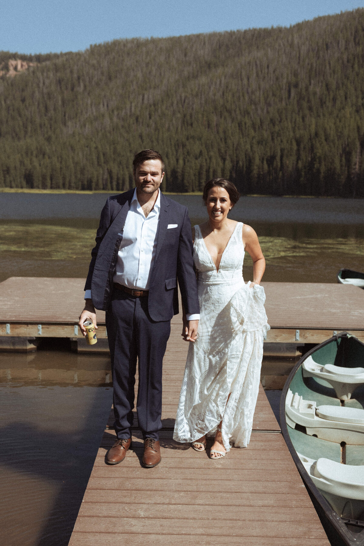 Bride and groom on the pier with the forest behind them in Vail Colorado.