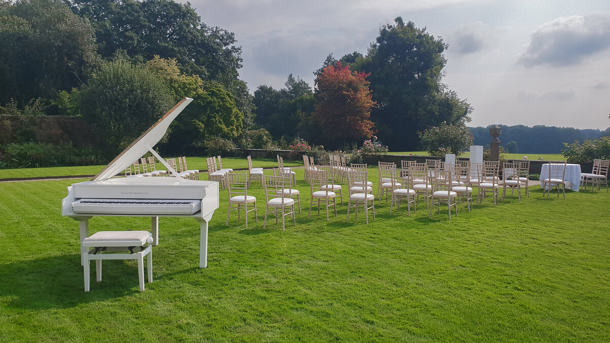 white baby grand piano outside wedding ceremony cheshire