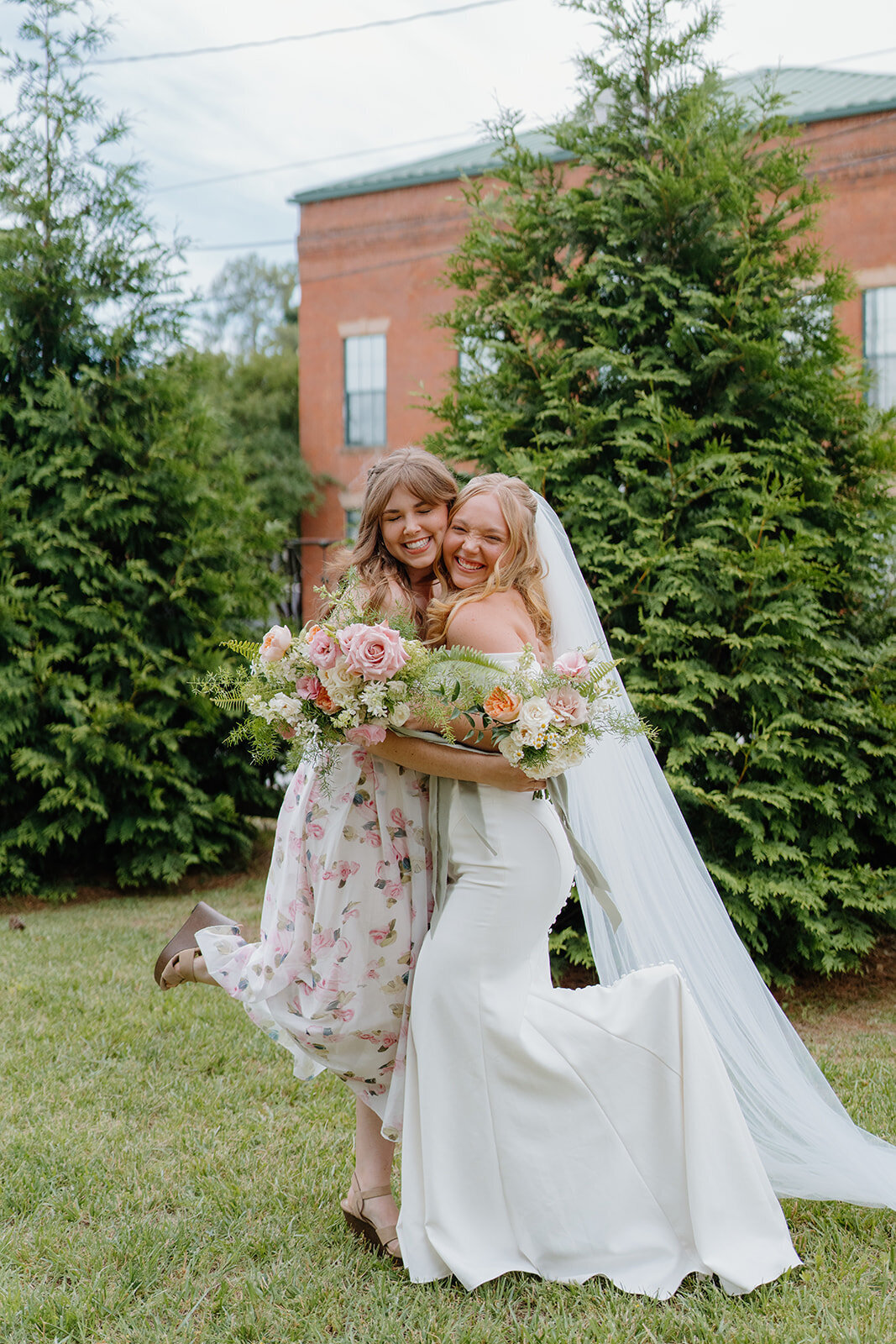 Bride and bridesmaid with bouquets designed by Abby Grace Florals at Easley SC wedding