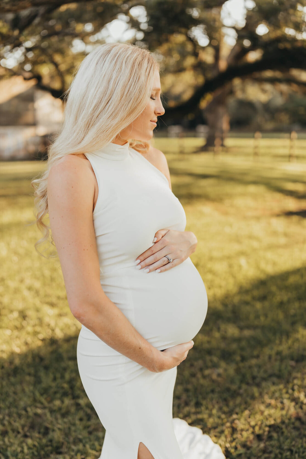 pregnant mom holds her belly and closes her eyes, dreaming of her baby boy.