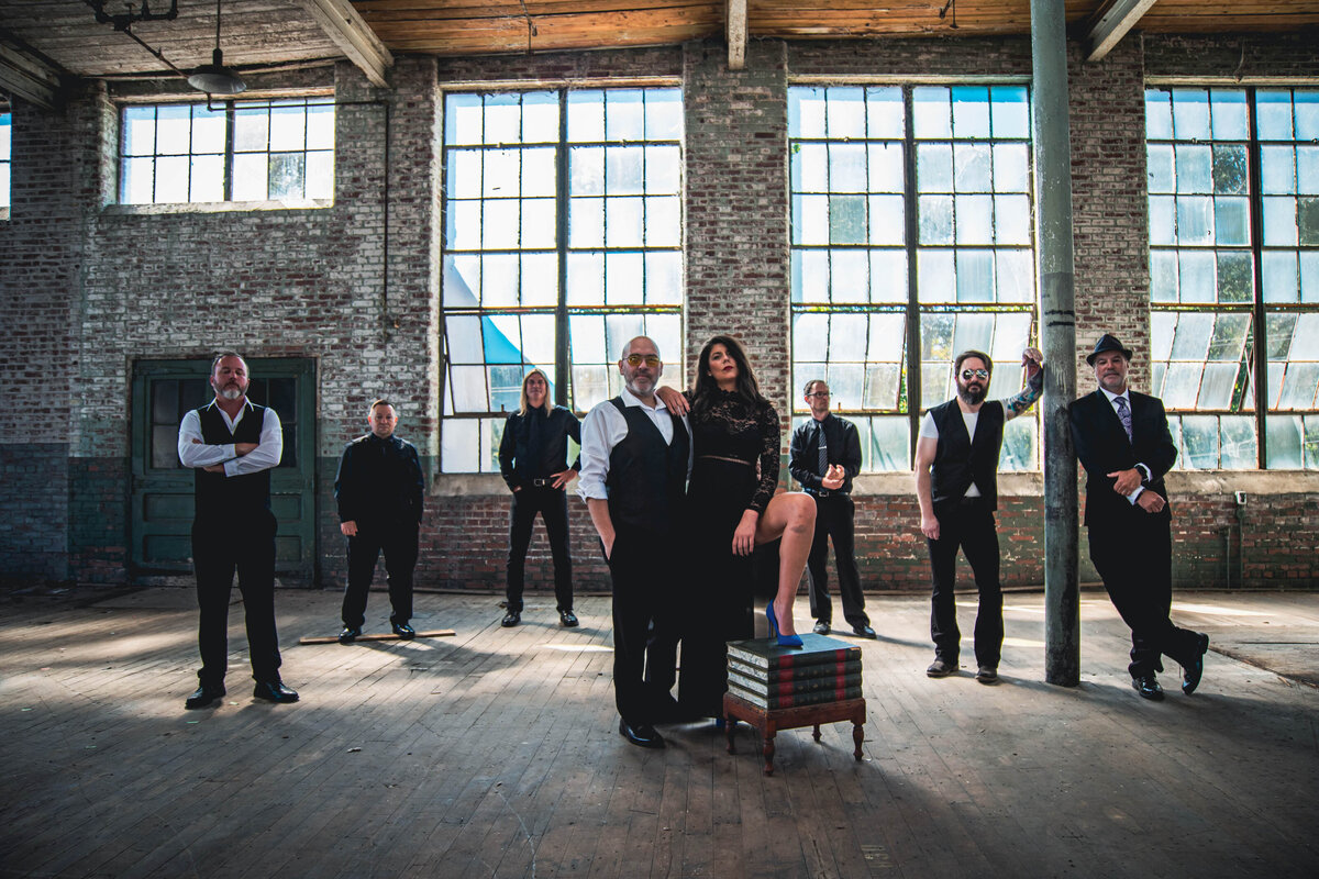 A band standing together in an empty building 
