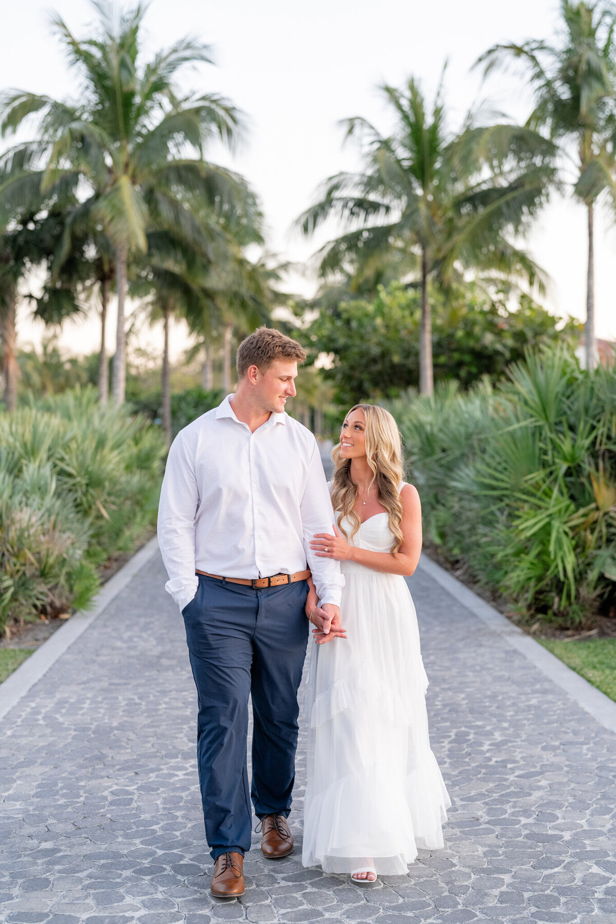 Couple holding hands and smiling at each other 