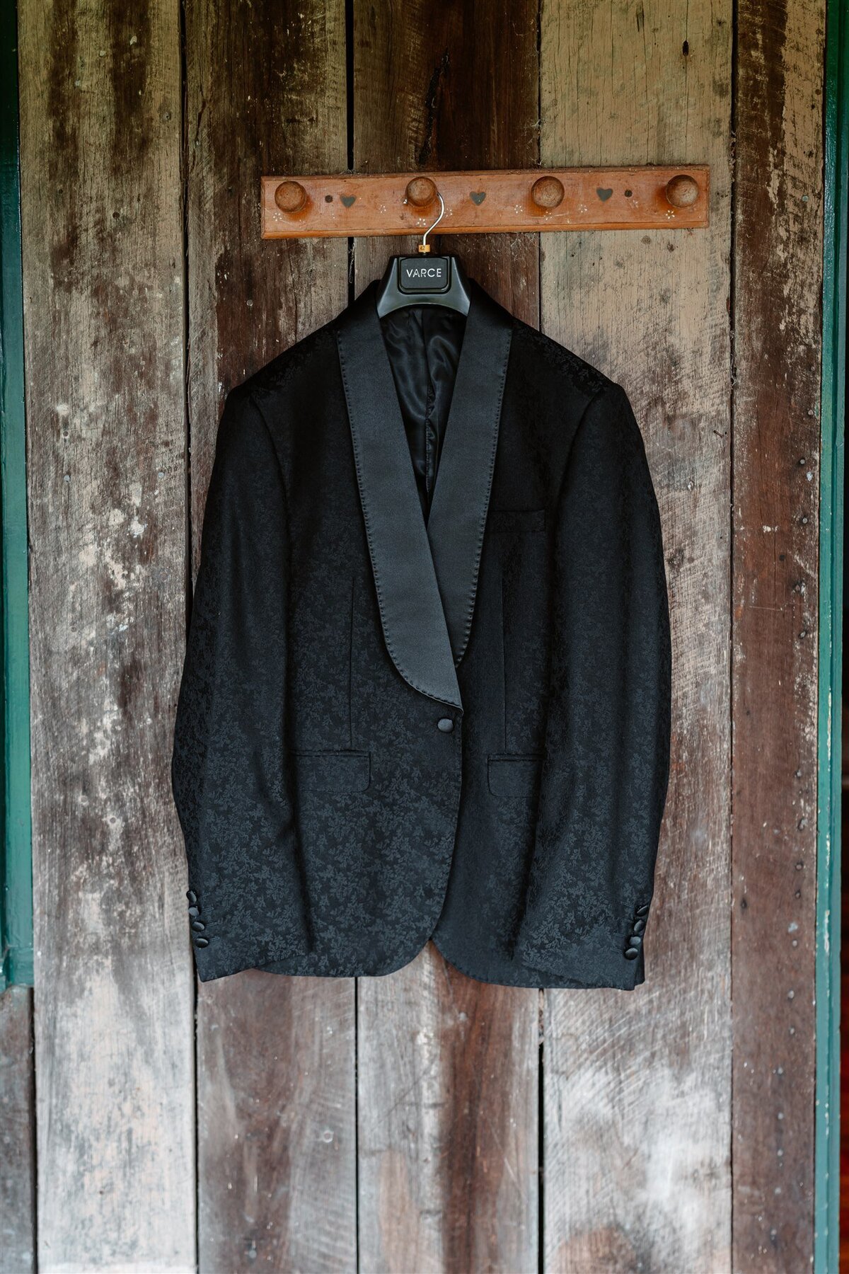 A close-up of the groom's attire showcasing intricate details like the stitching on the lapel or the pattern of the fabric.