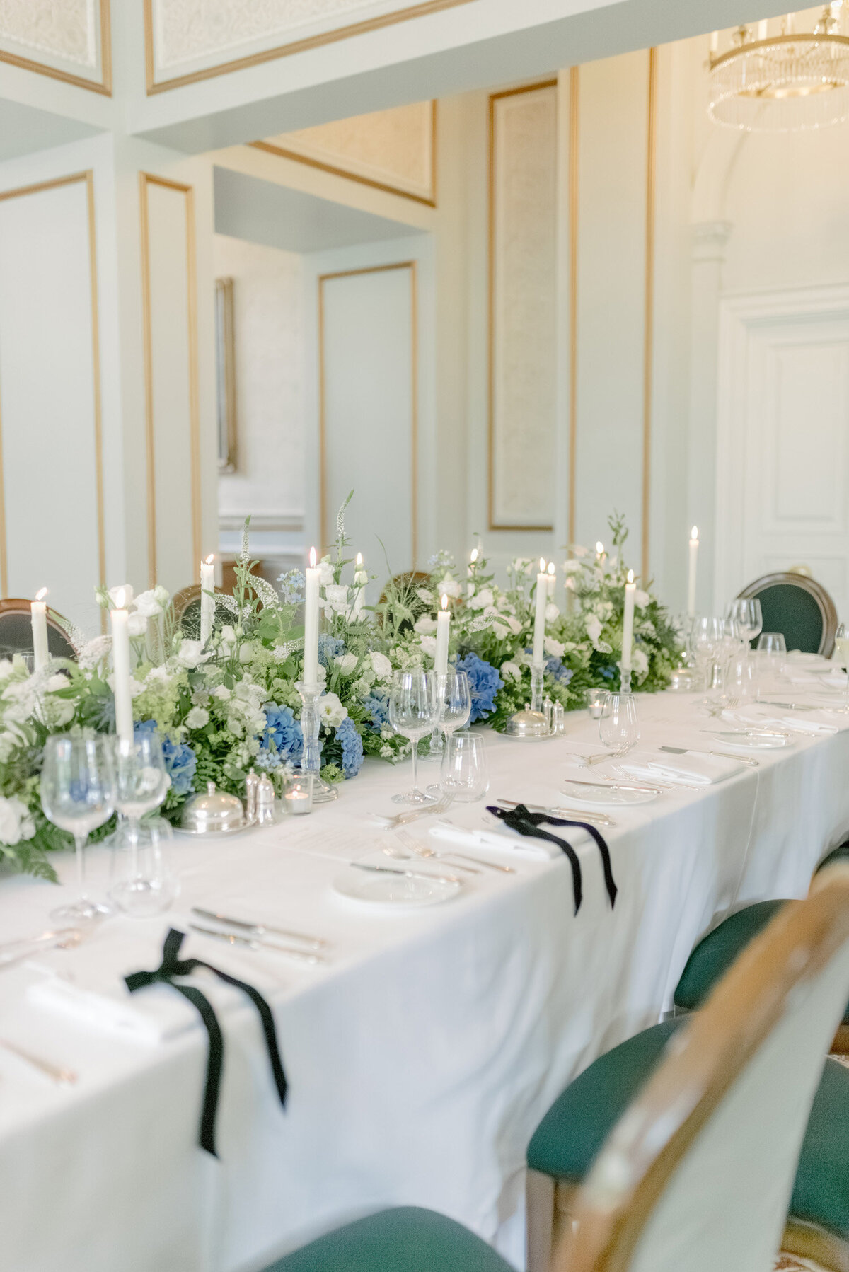 Wedding table with velvet bows, taper candles and flowers by Wild Burnett on a Gleneagles wedding day. Image by luxury fine art wedding photographer Scotland, Jill Cherry Porter.