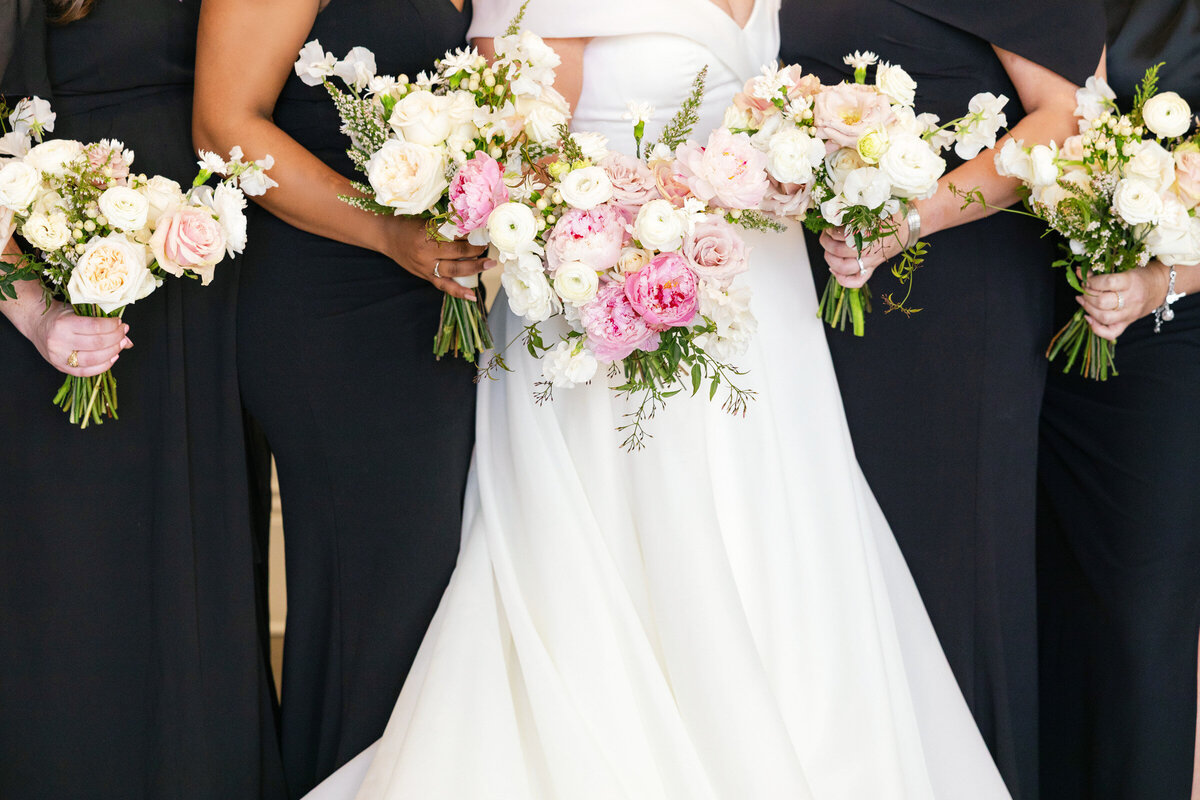 close up of the bride and bridesmaids’ floral bouquets at The Adolphus in Dallas, featuring pink roses and elegant wedding floral arrangements.
