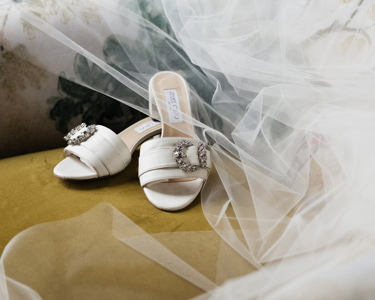 Jimmy choo wedding shoes for bride sitting on chair
