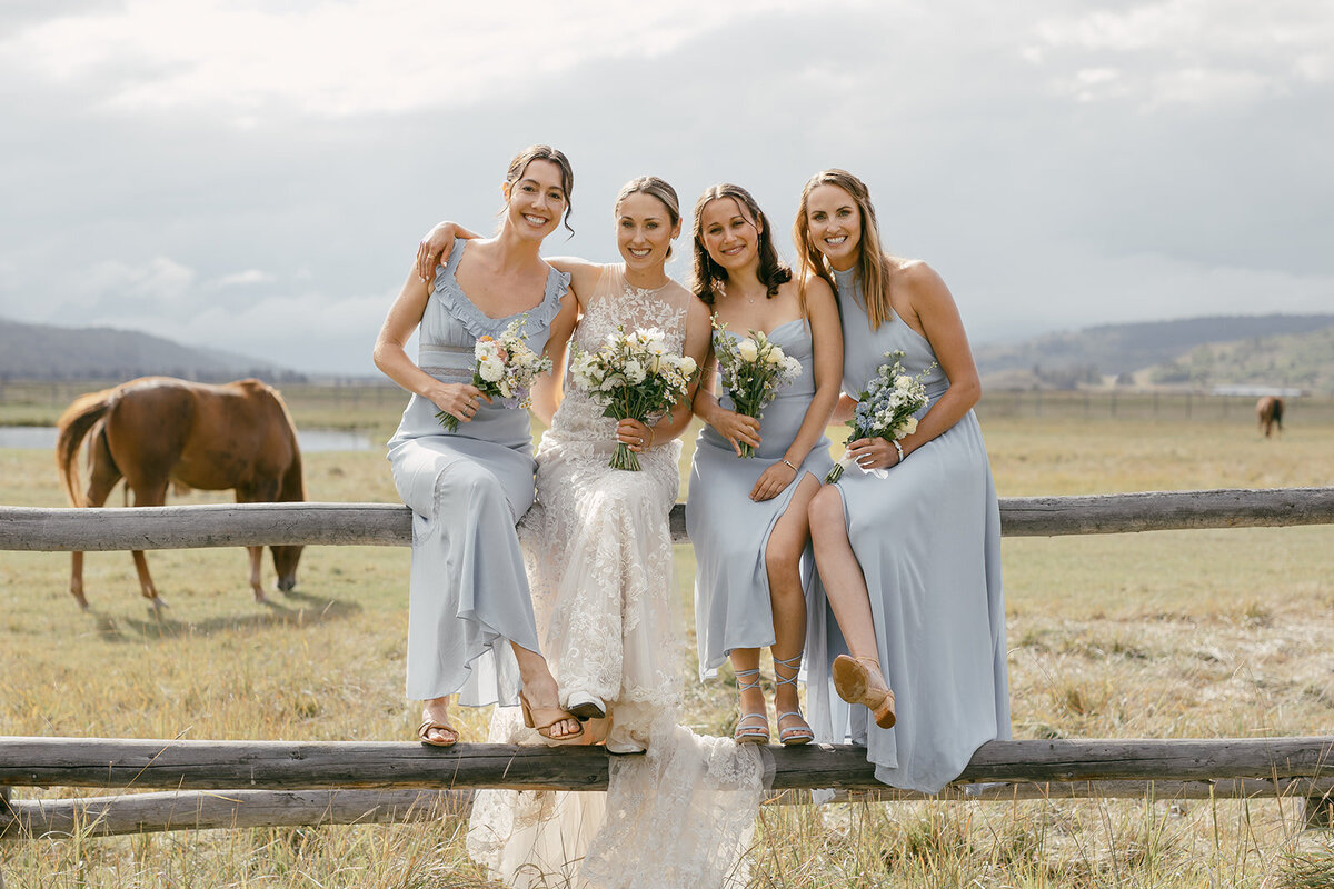 Bride-bridesmaids-tetons-horses-ranch-wedding-diamond-cross-light-blue-dresses