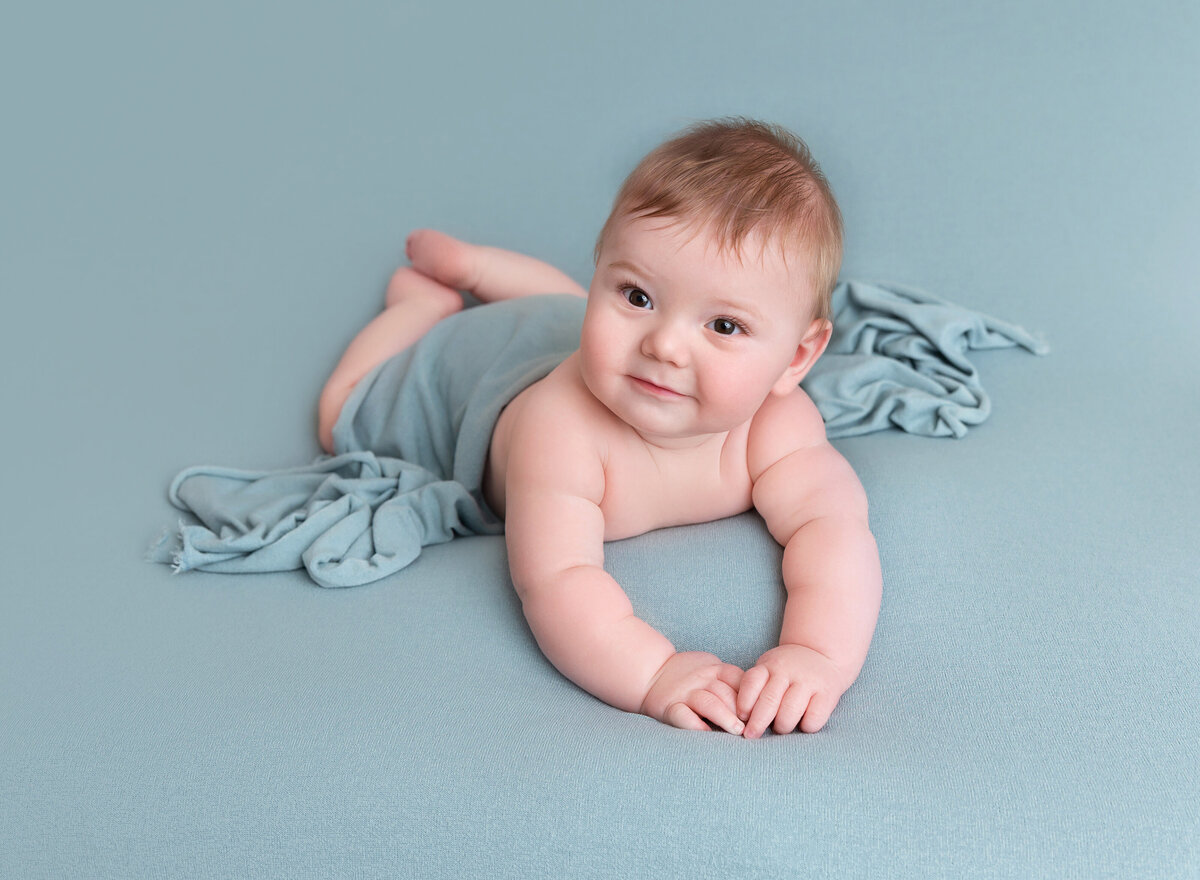 Baby boy on teal blanket 6 months old pictures Brooklyn NYC