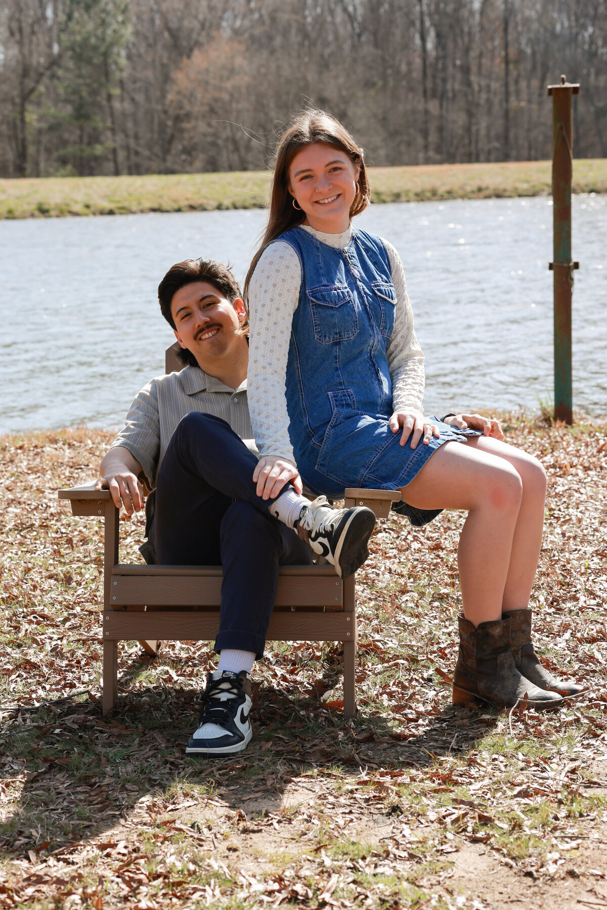engaged couple sitting on chair wearing brown boots in Columbus Georgia by Hamilton Georgia wedding photographer Amanda Richardson Photography
