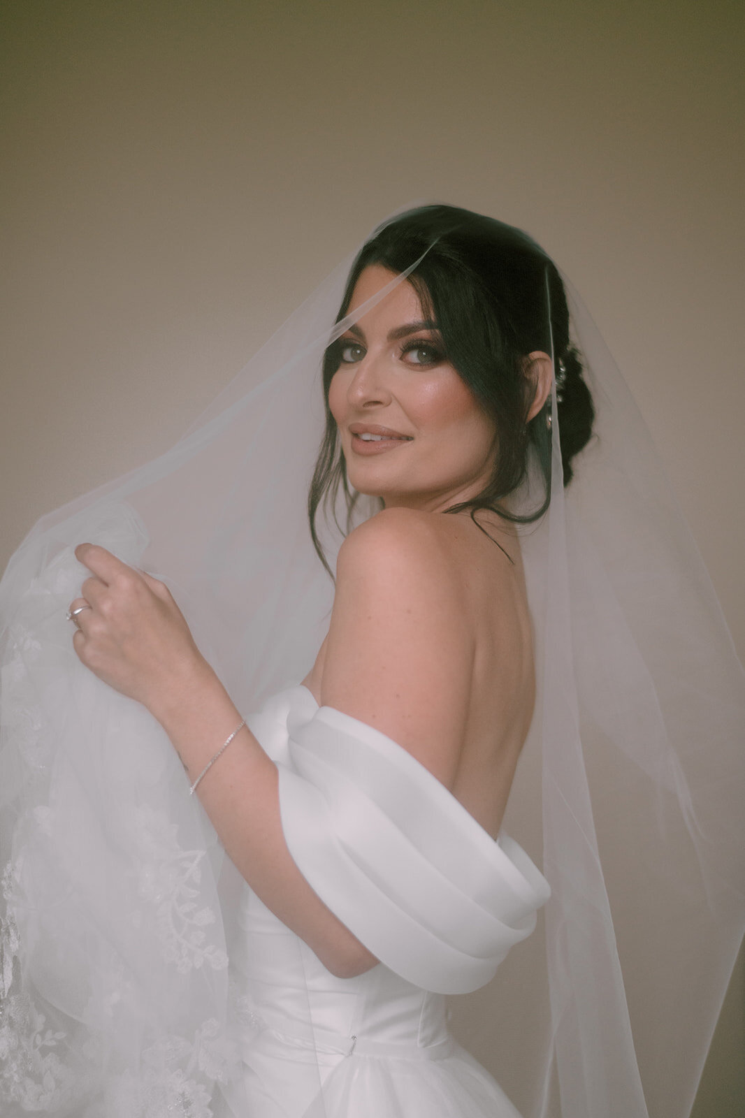 bride smiles with veil over face at her wadsworth mansion wedding photo by cait fletcher photography