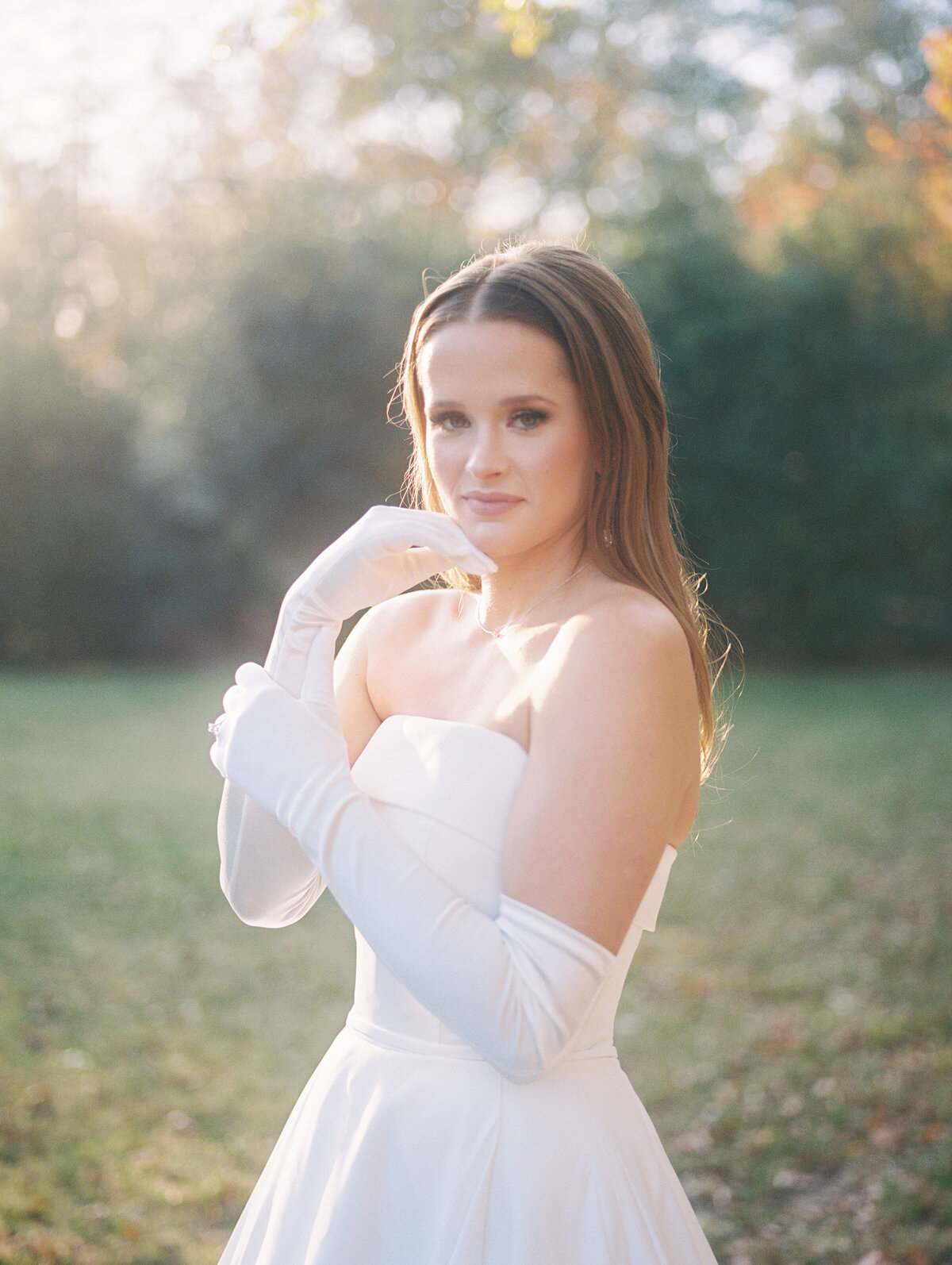 editorial bride posing in gloves and strapless modern dress