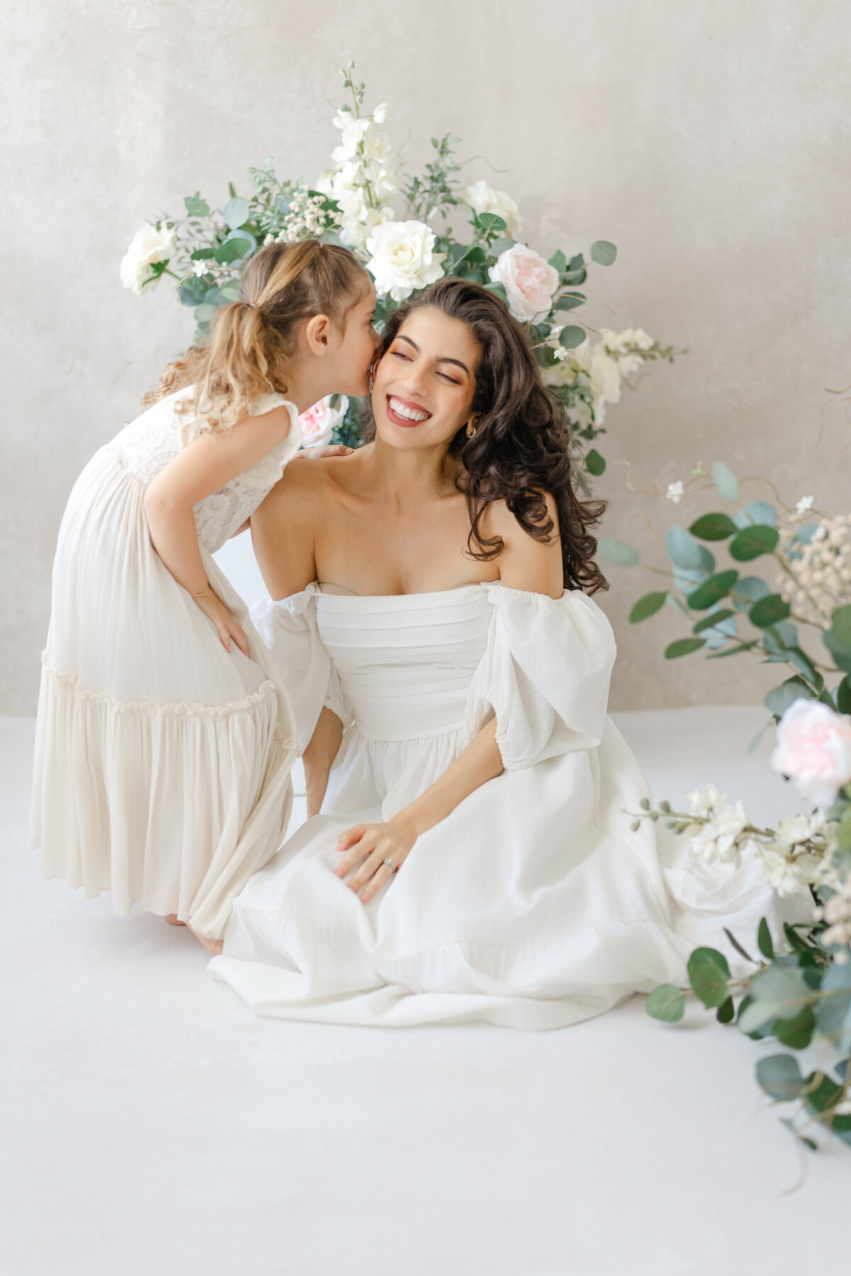 Joyful Tampa motherhood portrait of daughter kissing mom on the cheek