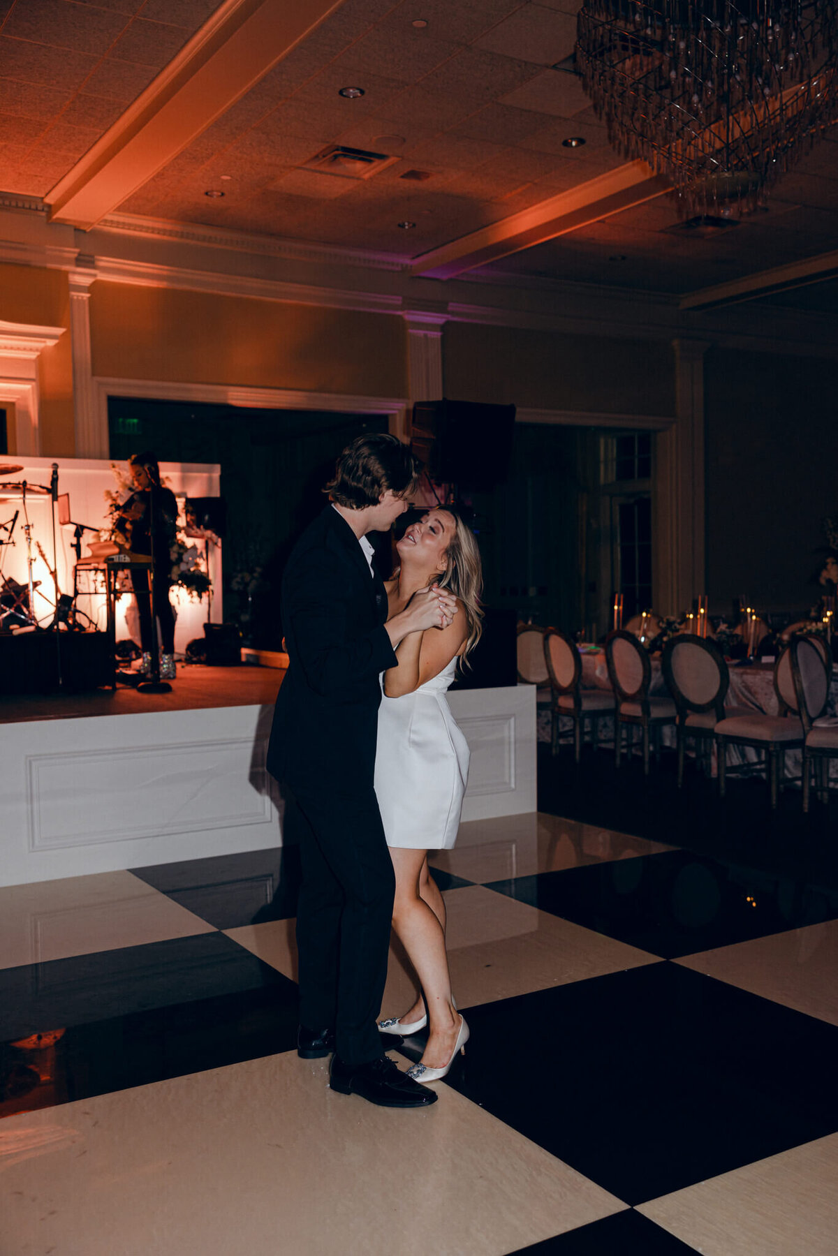 A wedding photo oft he bride and groom dancing during the wedding reception