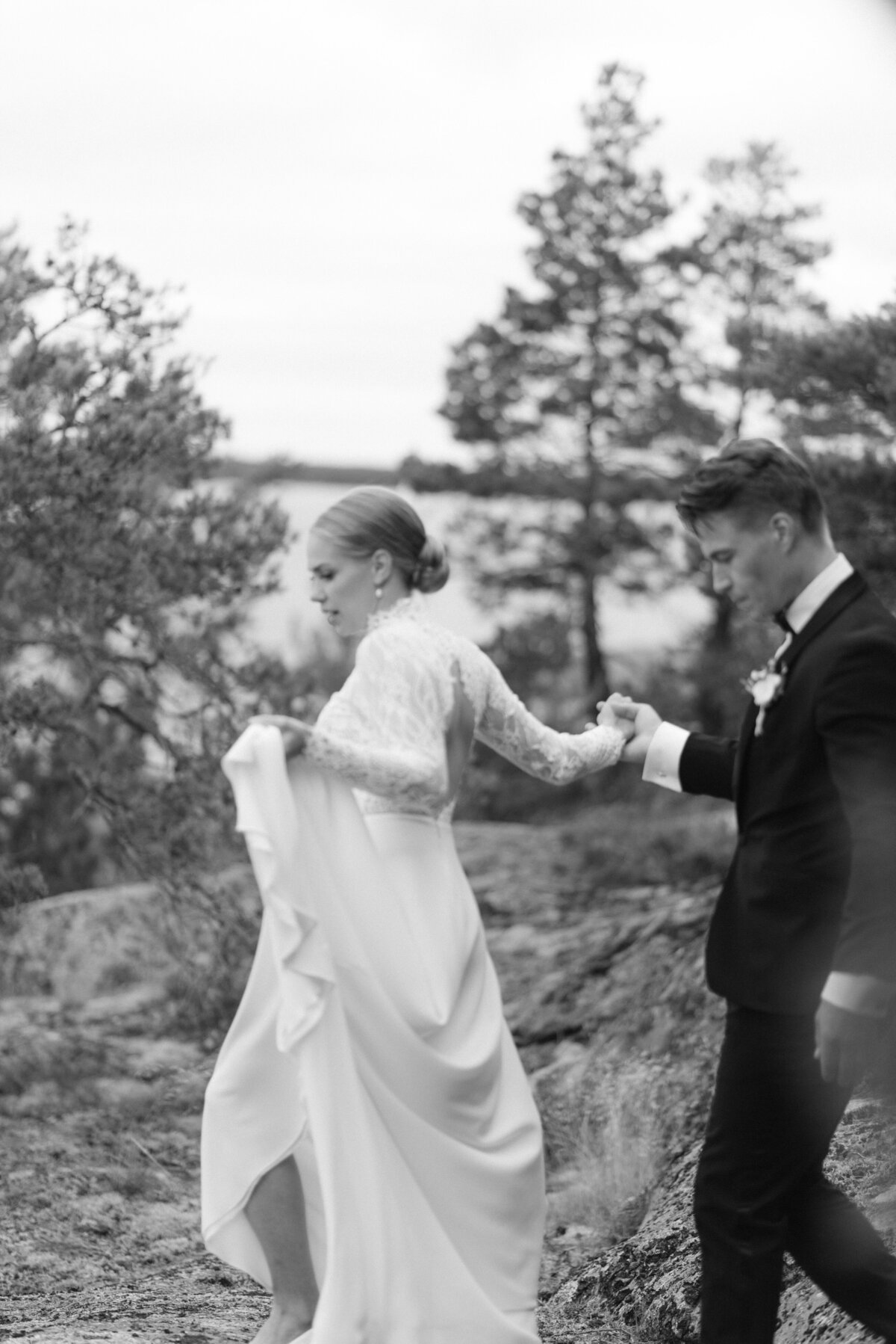 Wedding couple walking hand in hand during their wedding photography with  photographer Hannika Gabrielsson.