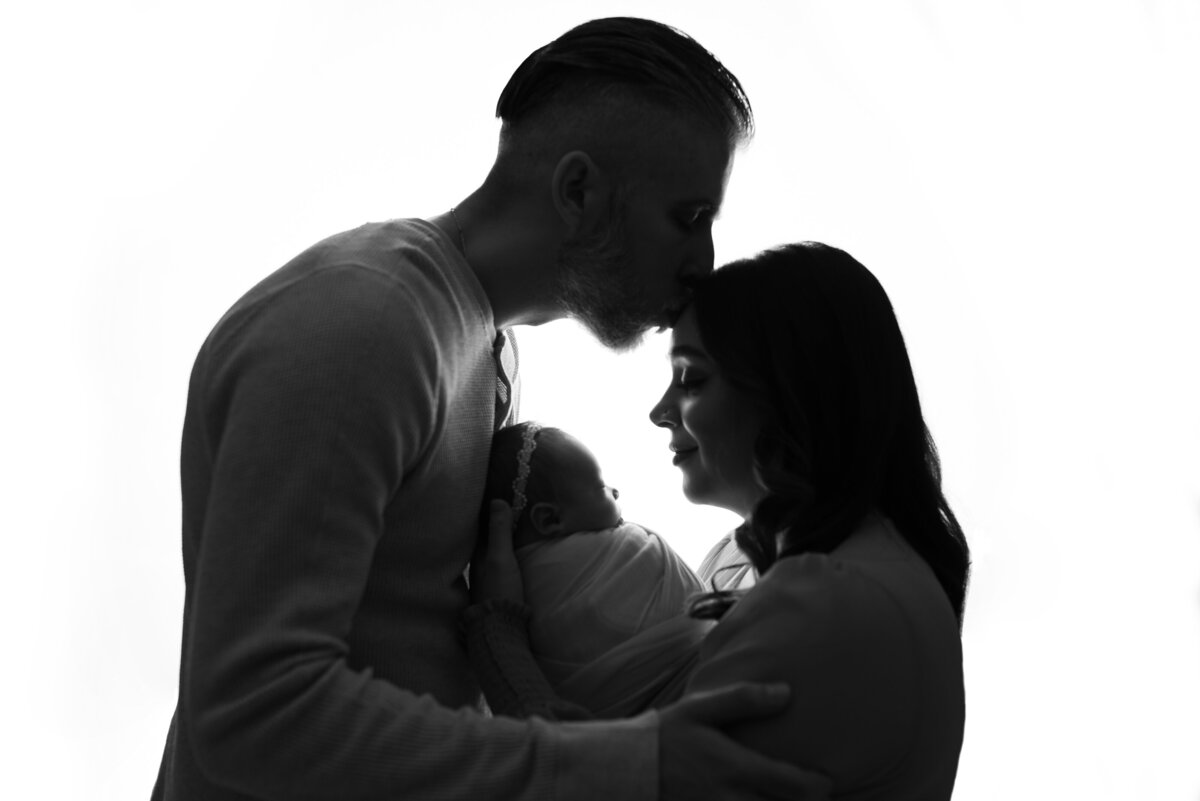 Beautiful newborn family portrait on tan backdrop at newborn photography studio in Marietta, GA, Casey McMinn Photography