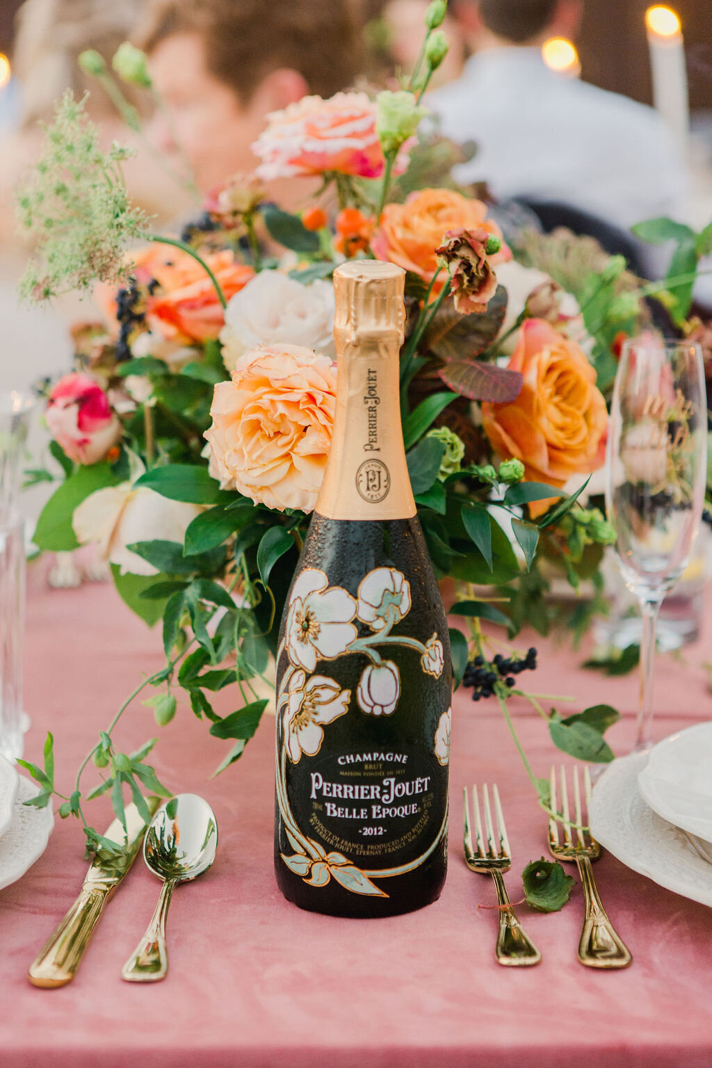 Custom champagne bottle with beautiful, lush florals by Vella Nest Floral Design in Fort Worth